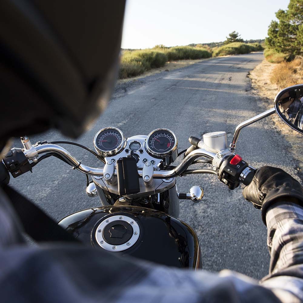 back-view-of-man-riding-motorbike-on-open-road-C5YMLS2.jpg